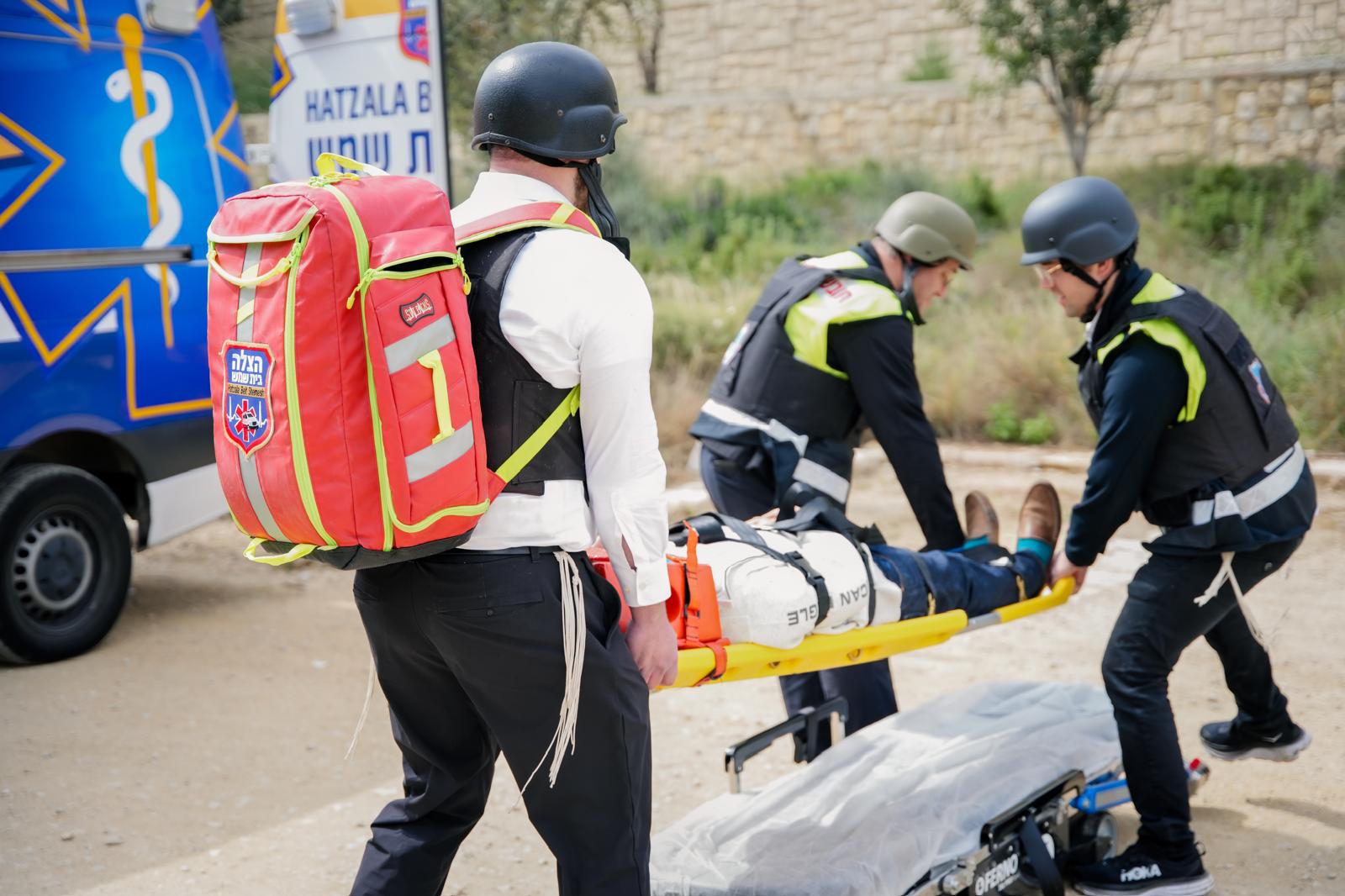 HatzBS team carrying a patient on a stretcher during a drill